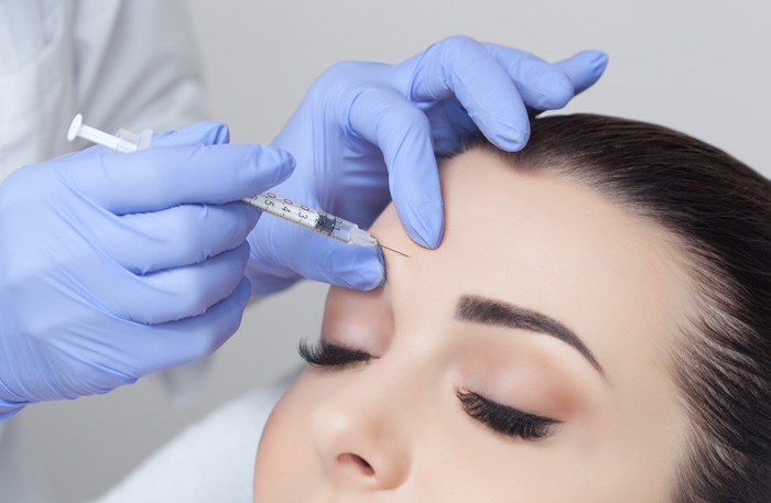 A woman receiving Botox for the forehead.